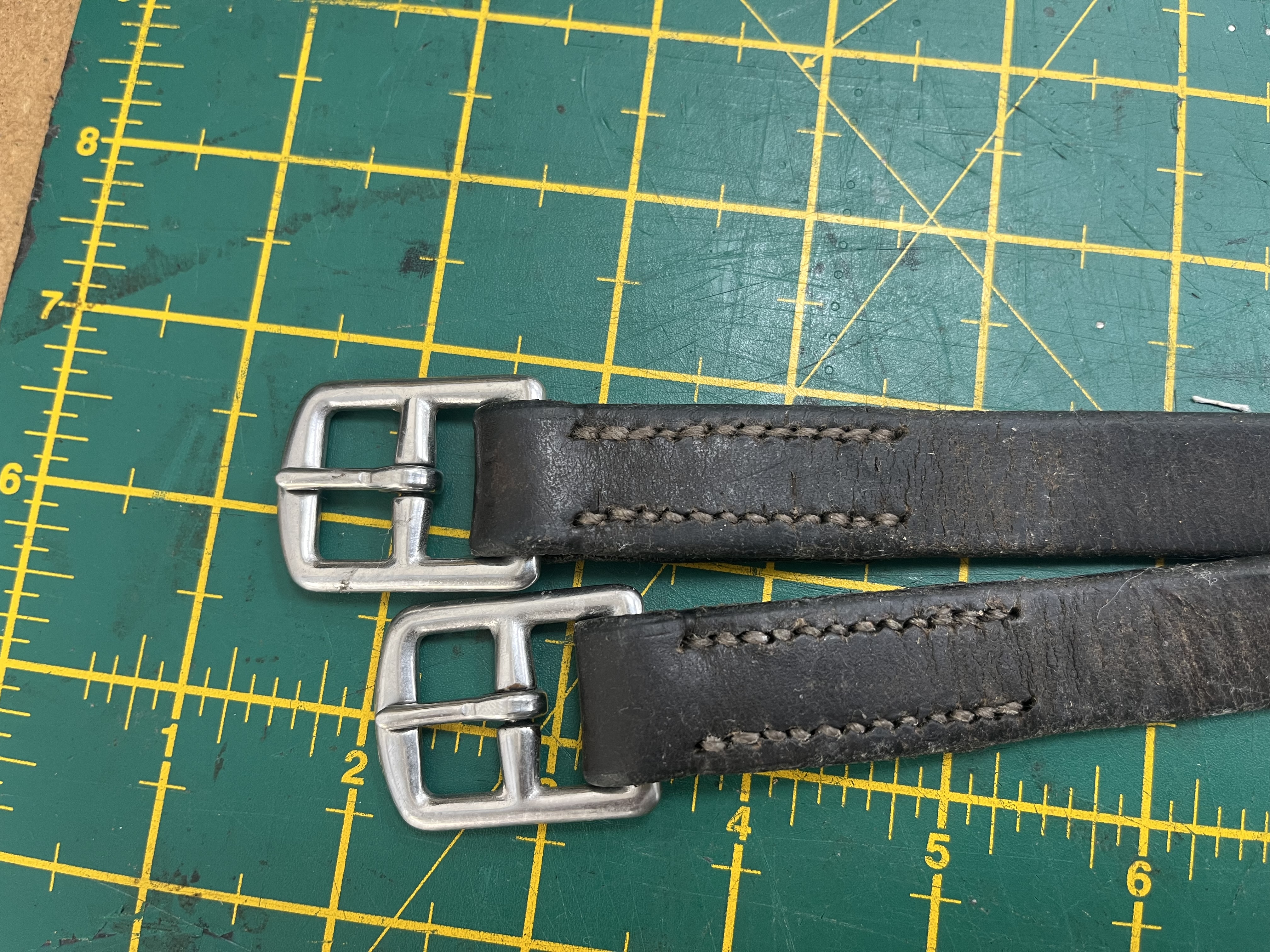 Stirrup leathers after repair — restored and re-stitched